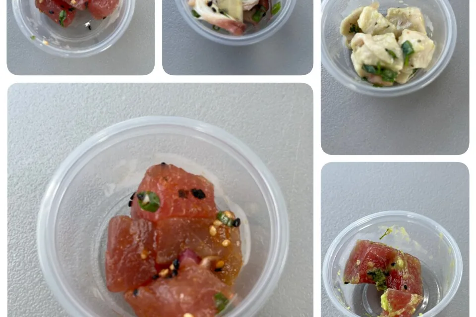 Small tasting cups of poke and other dishes on a food tour